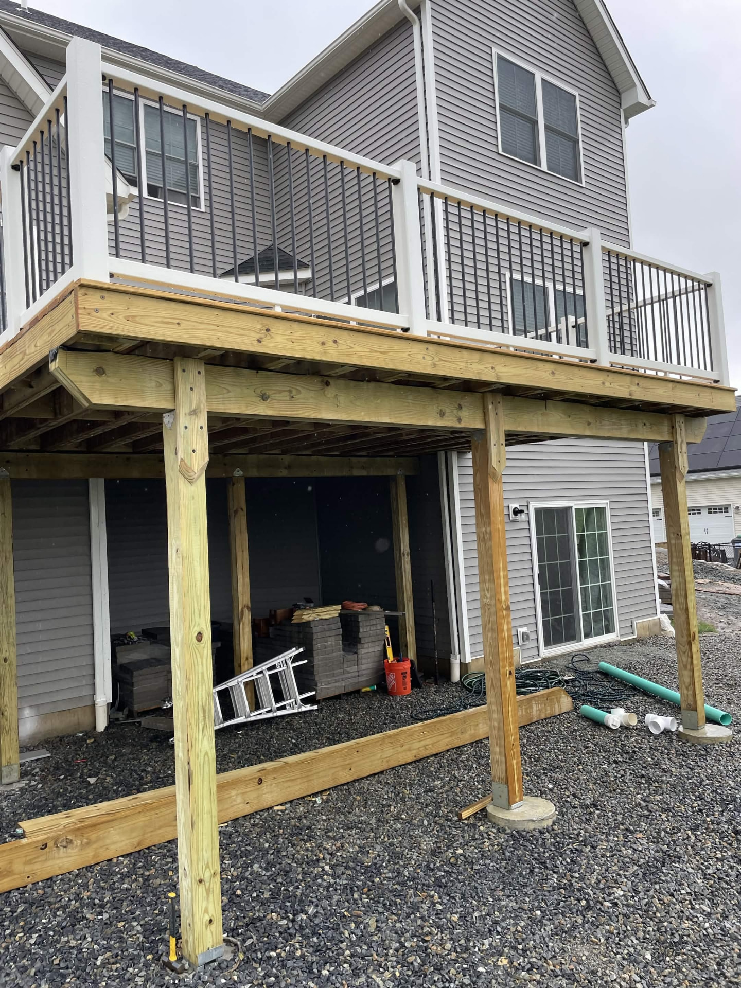 Deck posts and framing prepared over a new gravel pad