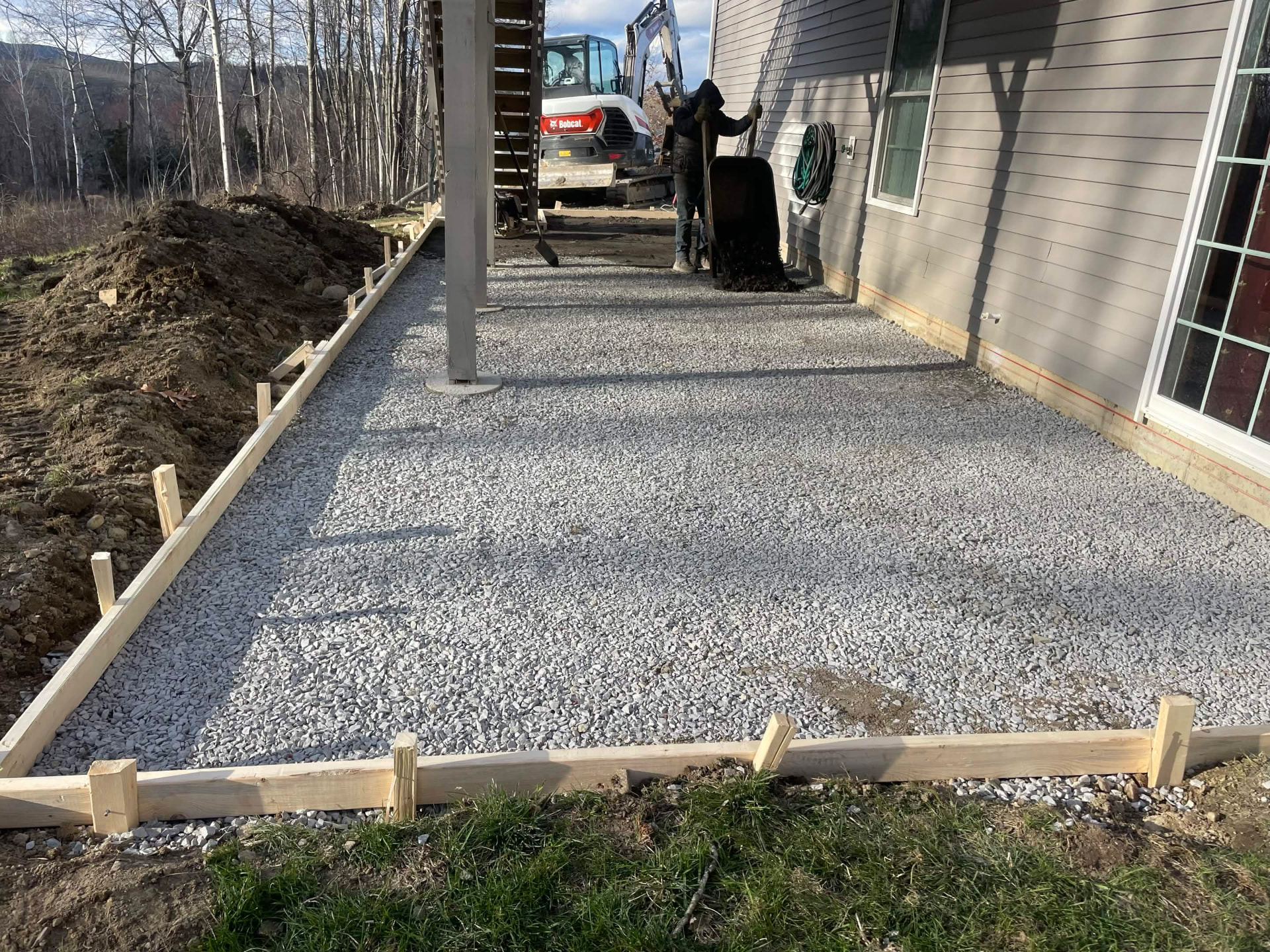 Compacted gravel base and forms set for a concrete pour