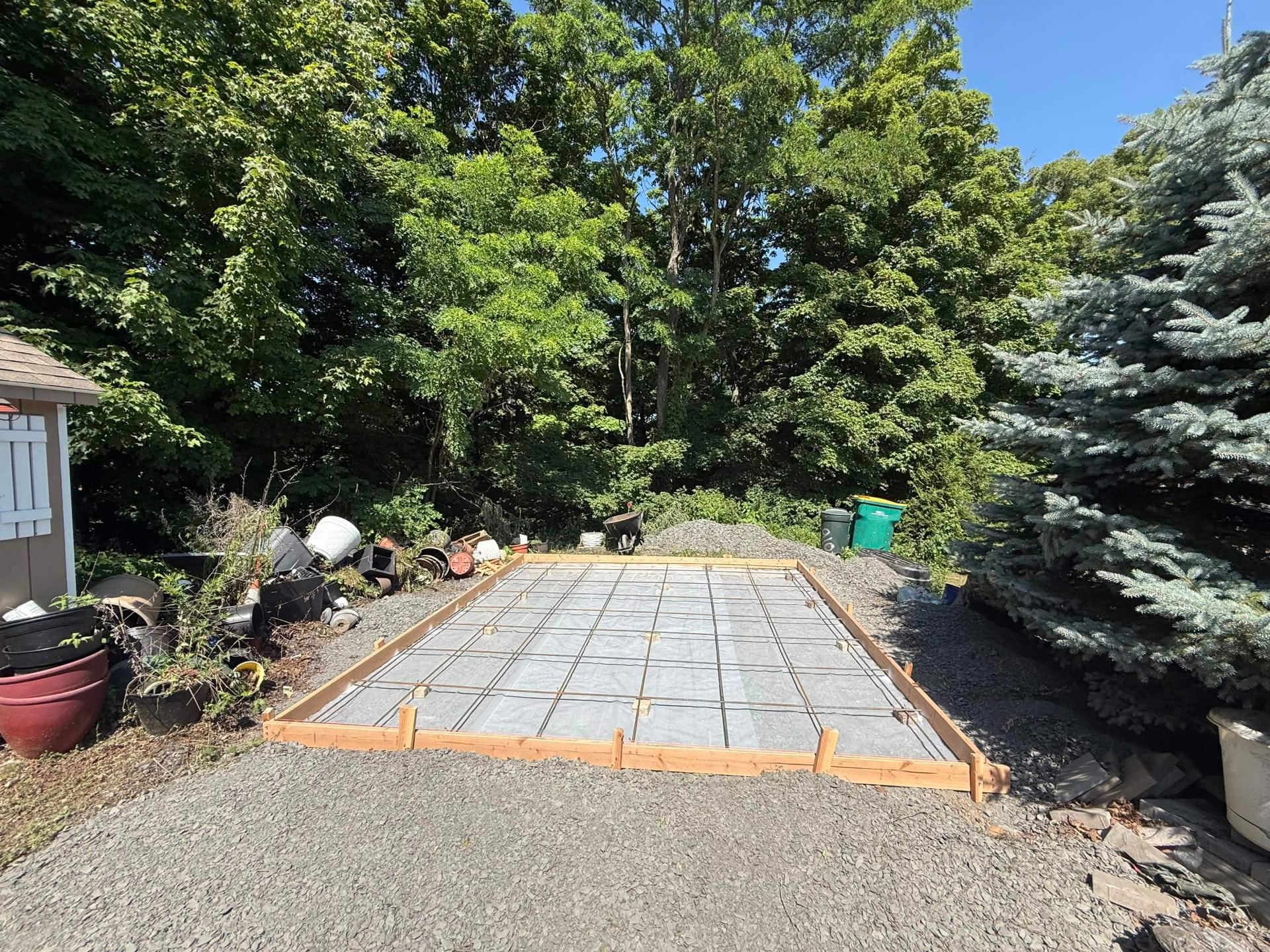 Paver patio base being set with edge restraints