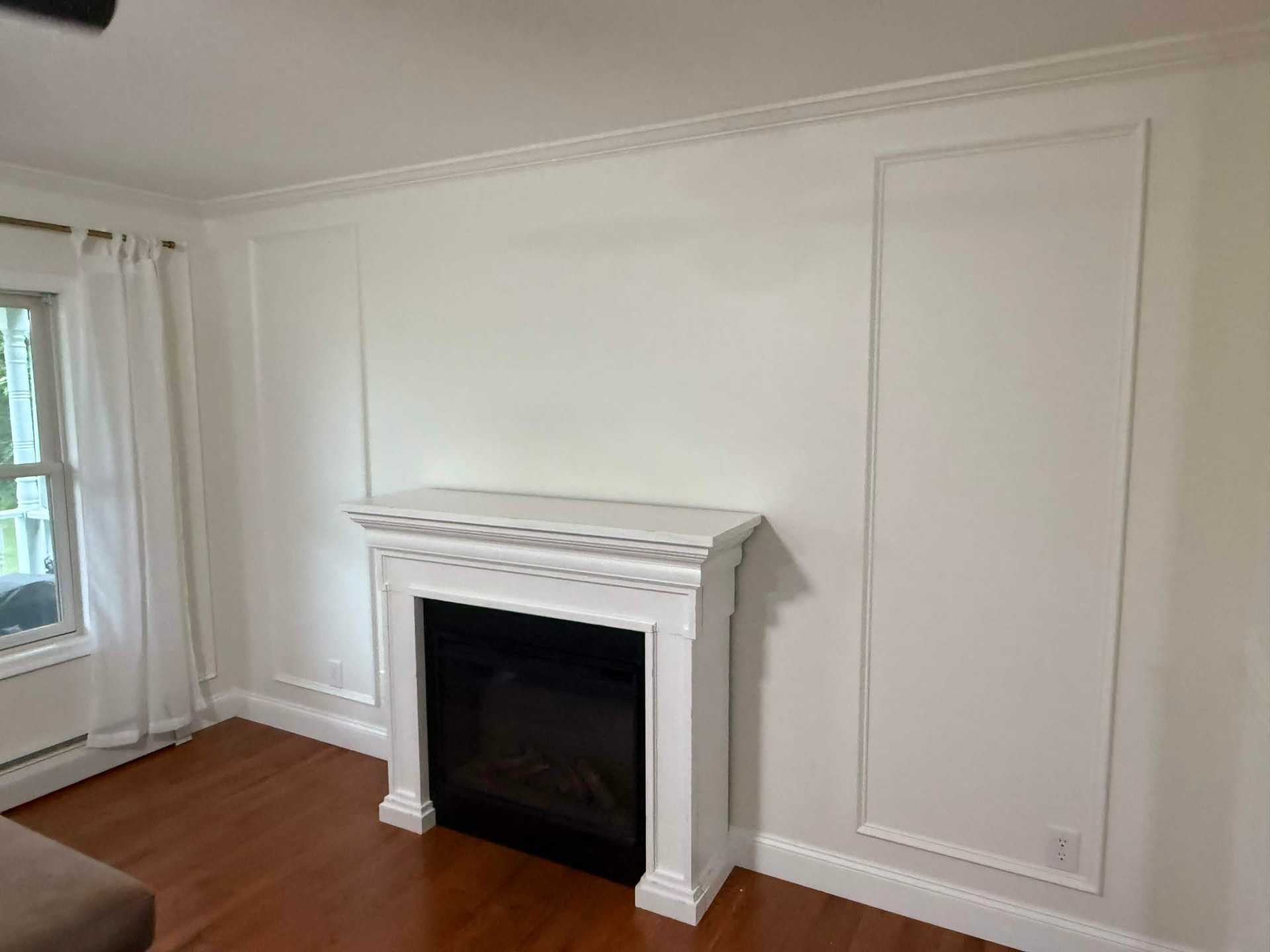 Fireplace surround framed by custom wall molding