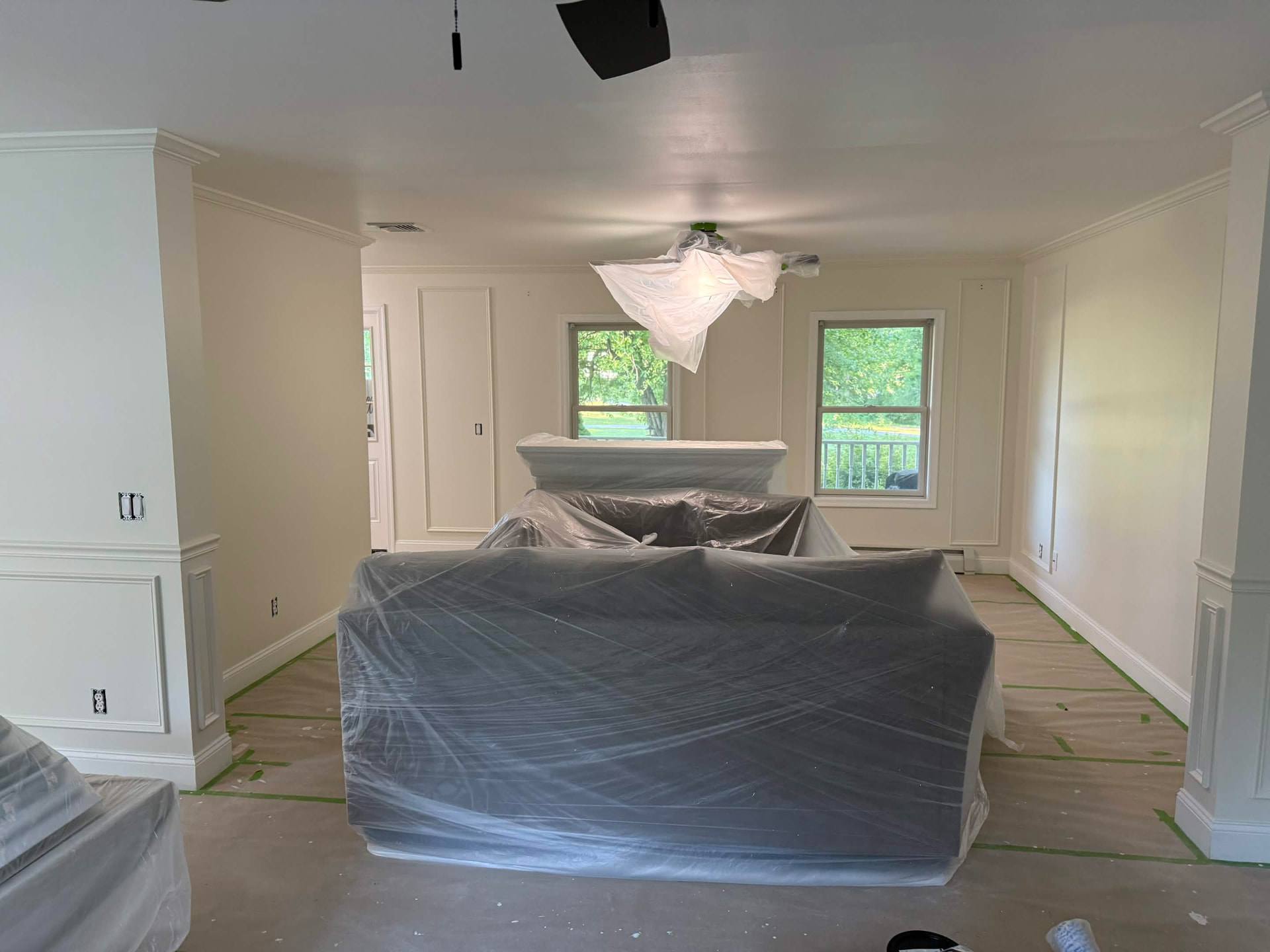 Furniture covered and floors protected before painting